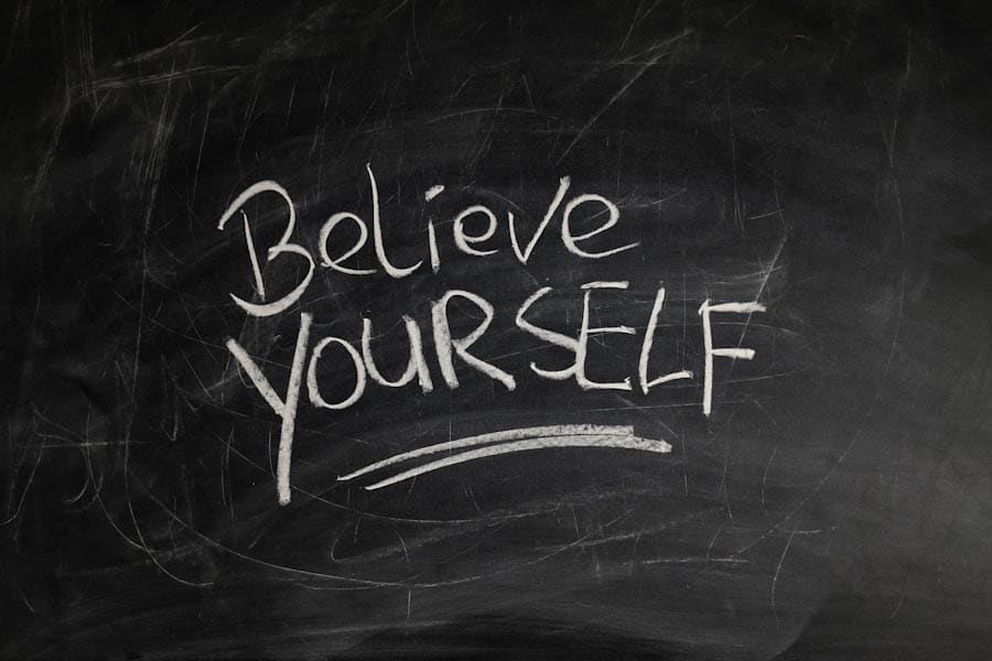 black board with signature "Believe yourself"